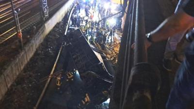 The bus crashed off a bridge near railway tracks