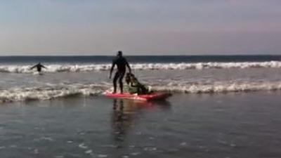 Kai, 13, tries out the tandem surfboard