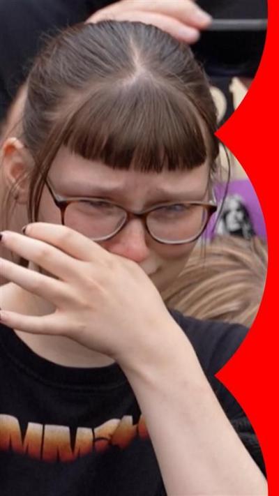 A fan cries during Ozzy Osbourne's funeral parade