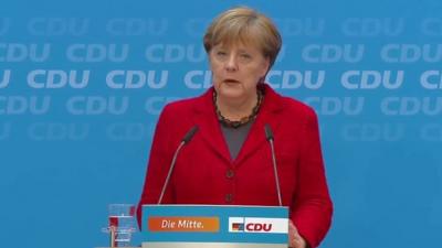 Angela Merkel at podium during press conference