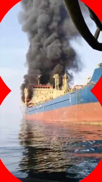 Smoke billows from an oil tanker under U.S. sanctions, that was hit off Oman's Musandam peninsula.