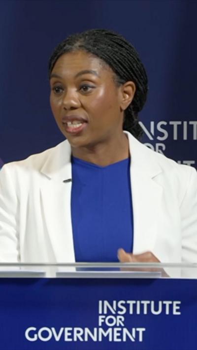 Kemi Badenoch standing behind a podium 