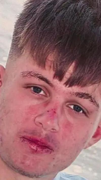 A teenage boy with a long, brown fringe.