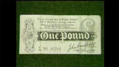 A £1 note on a green background.