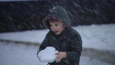 Boy with snowball in Scotland