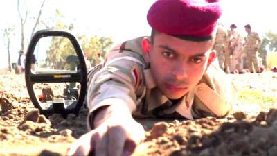An Iraqi soldier checking for a mine in training
