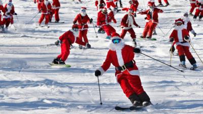 Skiing and snowboarding Santas