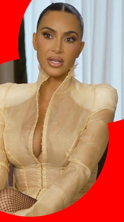 Kim Kardashian - she has her hair slicked back in a ponytail and is wearing a gold outfit