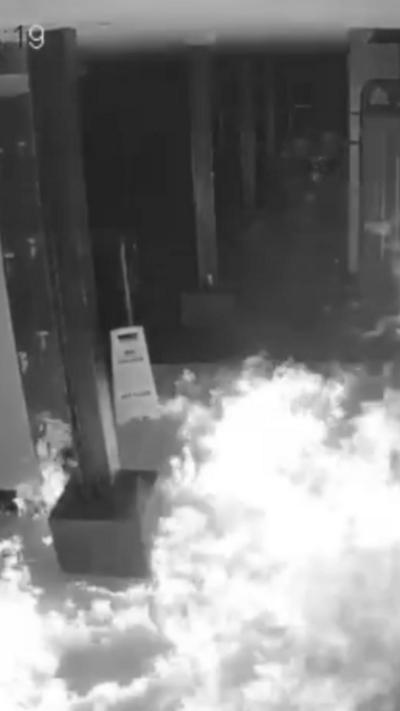 A fire in a gym caught in black and white on CCTV.