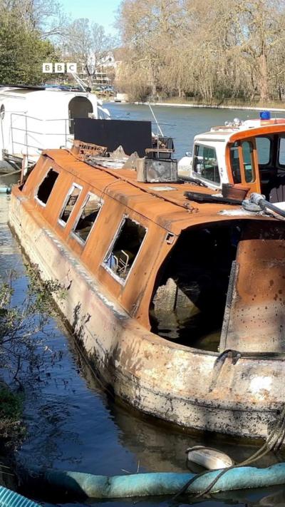 A rusty narrow boat on the River Thames