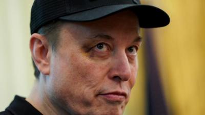Close-up of Elon Musk's face with a black eye.