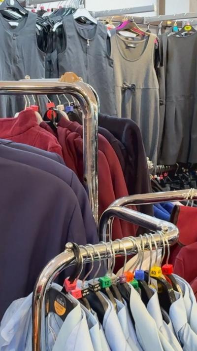 School uniforms hanging on clothes rail