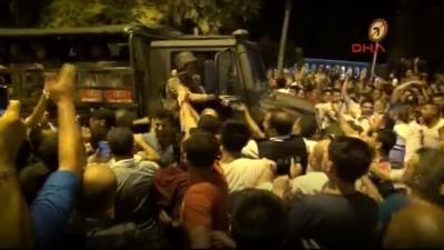 Armoured car surrounded by protesters