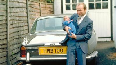 Harvey Bowden holding his baby child