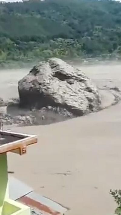 Massive rock rolls down in muddy waters