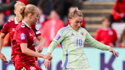 Wales' Jess Fishlock (R) runs with the ball