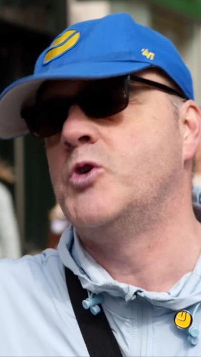A man wearing a Leeds United cap and badge
