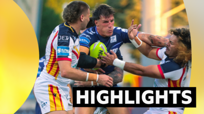 Lambert Belmas of Toulouse fends off Solomona Faataape of Catalans