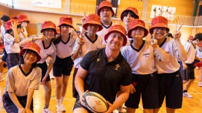 Tommy Reffell with some of the children during Wales' visit to Shinozaki Junior High School in Kitakyushu
