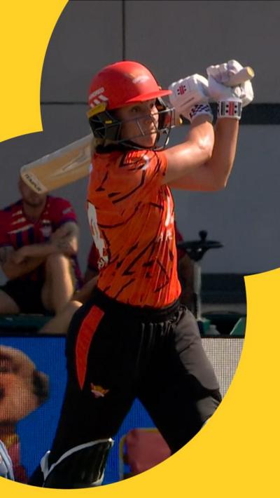 Annabel Sutherland mid-swing after sending the ball for a six