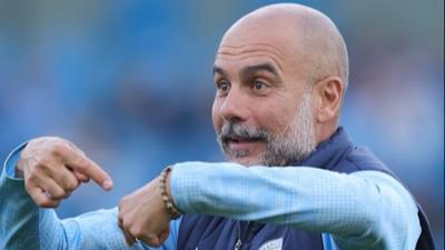 Pep Guardiola points at his wrist