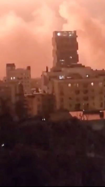 The flash of an explosion lights up the night sky over Tehran