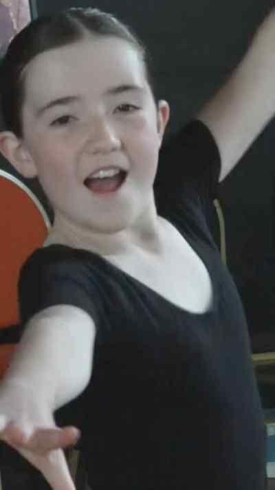 A young girl in a dance costume