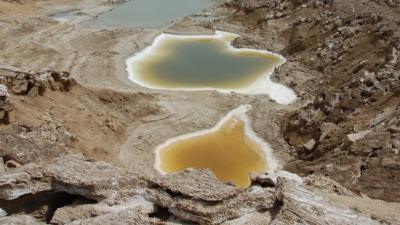 An image taken by a BBC drone above a series of sinkholes that appeared as the Dead Sea retreated