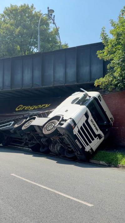 Lorry stuck under a bridge