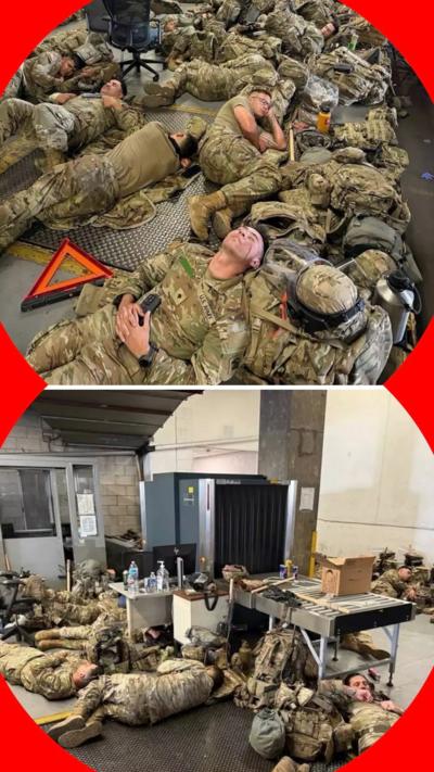 National Guard soldiers rest on the floor of an LA building