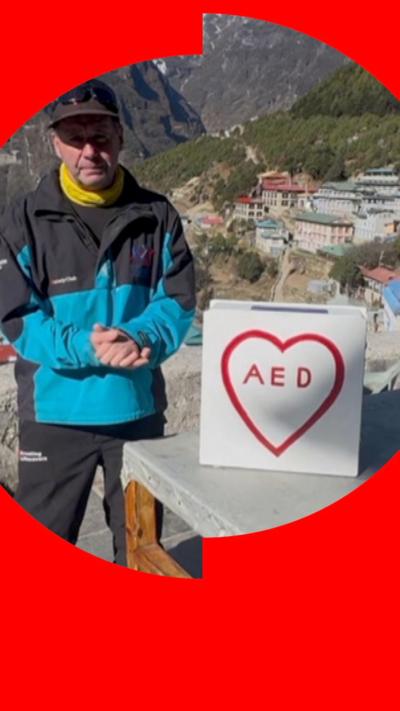 David Sullivan in hat and coat, with his defibrillator, on Everest.