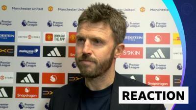Michael Carrick stands against advertising board in post match interview