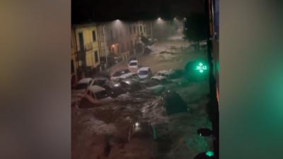 Cars and a bus swept away down street