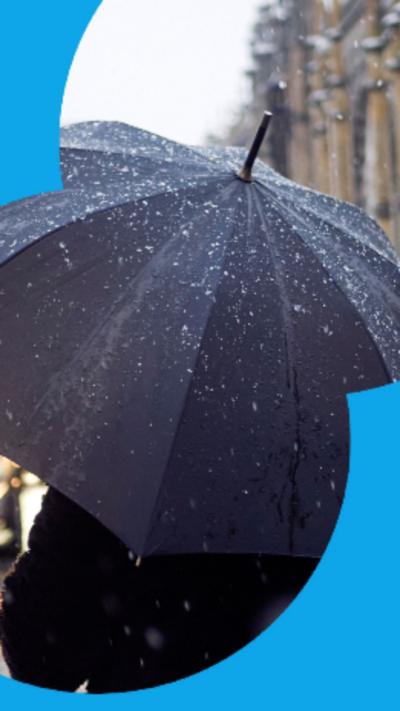 Person holding an umbrella in the rain.