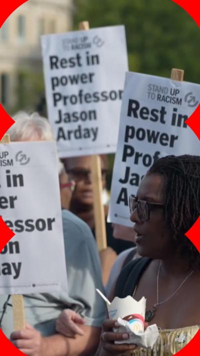 A group of people holding signs that read 'Rest in power Professor Jason Arday'