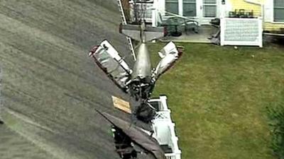 Crashed plane being lifted from roof