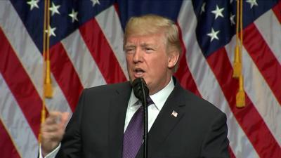 Trump in front of American flags