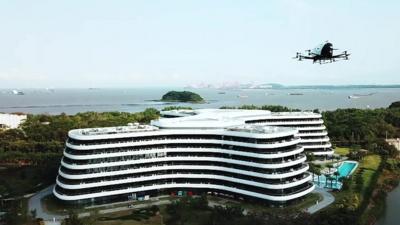 An automated aerial passenger vehicle flies towards a hotel