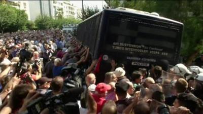 pensioners trying to topple a bus