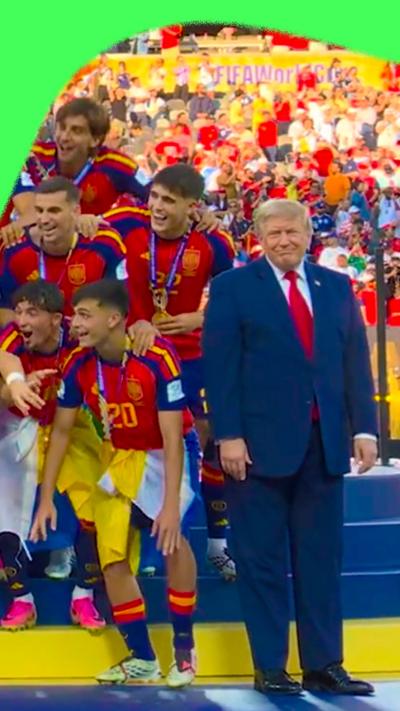 President Donald Trump stands as Spain lifts the trophy at the World Cup final 