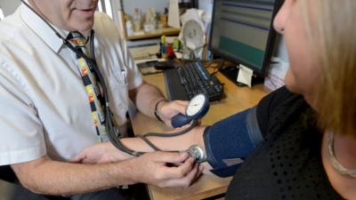 Doctor taking a patient's blood pressure