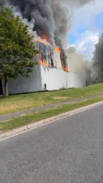 Fire and smoke billows from windows of gym building