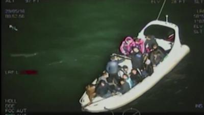 Smugglers and migrants on inflatable boat