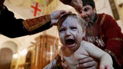 A baby being baptised.