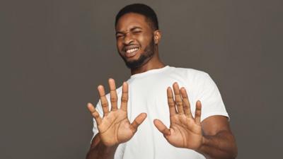 Man holding his hands up as he takes offence at something