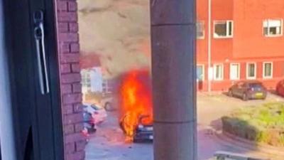 A taxi burns after exploding by a Liverpool hospital