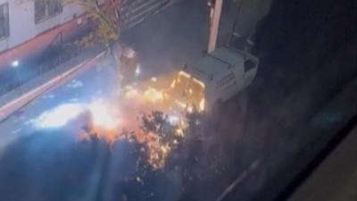 Vehicles are shown after the aftermath of a car explosion.