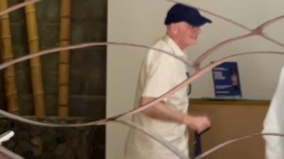 Infantino in a blue cap behind a fence