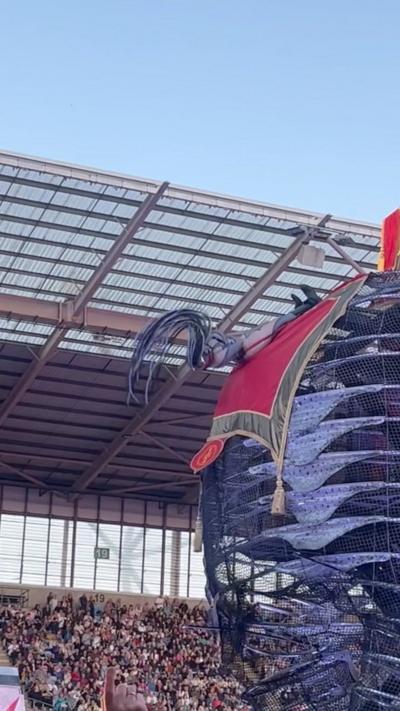 Performer Briony swinging from the back of a steel elephant in her role as the tail 