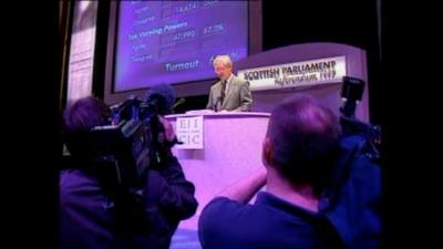 Scottish Secretary Donald Dewar speaks on stage.